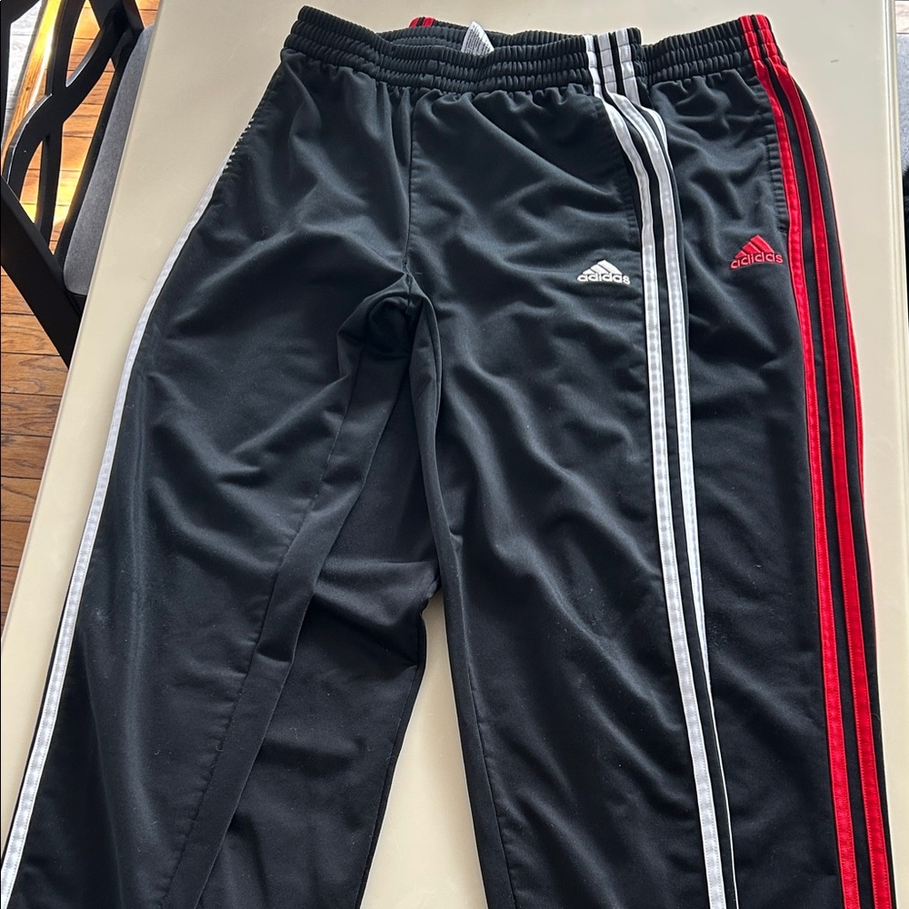 2 pack of Adidas Kids Black Joggers. One with Red and one with White Stripes